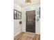 Bright entryway with dark gray door and wood-look flooring at 1581 Harborsun Dr, Charleston, SC 29412