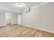 Spacious basement area with light wood flooring, fresh paint, and access to additional storage at 2265 Bailey Dr, North Charleston, SC 29405