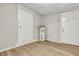 Unfinished basement area with modern flooring, a water heater, and access to a utility closet at 2265 Bailey Dr, North Charleston, SC 29405