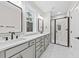 Bathroom featuring a double vanity with framed mirrors, black shower and modern fixtures at 5874 Hwy 165, Ravenel, SC 29470