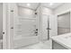 Bathroom with a shower and bathtub combo, modern fixtures, and white marble flooring at 5874 Hwy 165, Ravenel, SC 29470