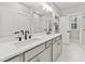 Bathroom features a double sink vanity with modern matte black faucets and marble tile flooring at 5874 Hwy 165, Ravenel, SC 29470