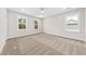 Bedroom features three windows allowing natural light and neutral carpet at 5874 Hwy 165, Ravenel, SC 29470