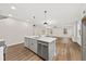Open-concept kitchen featuring an island, stainless steel appliances, and seamless flow to the living area at 5874 Hwy 165, Ravenel, SC 29470