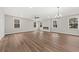 Bright, expansive living room featuring luxury vinyl flooring, a fireplace, and ample natural light at 5874 Hwy 165, Ravenel, SC 29470