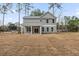 Rear elevation of a home with a covered patio and large backyard at 5876 Hwy 165, Ravenel, SC 29470