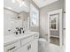 Bathroom with a double vanity, matte black fixtures, a large window, and a shower at 5876 Hwy 165, Ravenel, SC 29470