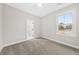 Bedroom features neutral carpet, ceiling fan, and a window with bright natural light at 5876 Hwy 165, Ravenel, SC 29470