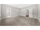 Bedroom with neutral carpeting and trim, two doors and a bright window at 5876 Hwy 165, Ravenel, SC 29470