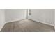 A carpeted bedroom with a large window, base trim, and neutral paint at 5876 Hwy 165, Ravenel, SC 29470