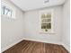 Cozy bedroom with two windows offering natural light and hardwood floors at 5876 Hwy 165, Ravenel, SC 29470
