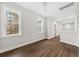 Bright hallway with wood-look flooring, white trim, and natural light from two windows at 5876 Hwy 165, Ravenel, SC 29470