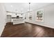 Well-lit kitchen with stainless steel appliances, modern pendant lights, and a large island at 5876 Hwy 165, Ravenel, SC 29470