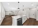Bright kitchen featuring a large island with modern appliances, pendant lighting, and open floor plan at 5876 Hwy 165, Ravenel, SC 29470