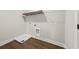 Well-lit laundry room with a utility sink, shelving, and wood-look flooring at 5876 Hwy 165, Ravenel, SC 29470