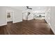 Open-concept living area with hardwood floors, a staircase, and a view of the kitchen at 5876 Hwy 165, Ravenel, SC 29470
