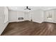 Open living area boasts a fireplace, natural light from large windows, and entry to the outdoors at 5876 Hwy 165, Ravenel, SC 29470