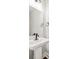 Modern powder room with a pedestal sink, updated fixtures, and a sleek mirror at 5876 Hwy 165, Ravenel, SC 29470