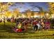 Residents gathering at dusk to enjoy an outdoor movie or concert on the community lawn at 742 Blueway Ave, Summerville, SC 29486