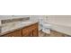 Bathroom with granite countertop, wood cabinets, and vinyl flooring at 1112 Moss Grove Dr, Moncks Corner, SC 29461