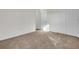 Bright bedroom featuring brown carpet and double door closet at 1112 Moss Grove Dr, Moncks Corner, SC 29461