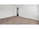 Bedroom with brown carpet, white door and double doors to closet at 1112 Moss Grove Dr, Moncks Corner, SC 29461