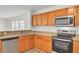 Modern kitchen with wood cabinets, granite countertops, and stainless steel appliances at 1112 Moss Grove Dr, Moncks Corner, SC 29461