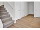 Gray carpeted stairs and light brown wood flooring at 1112 Moss Grove Dr, Moncks Corner, SC 29461