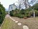 Charming backyard with stone path, lush landscaping, and a quaint patio area at 12 John St # Includes 8 & 10, Charleston, SC 29403