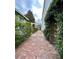 Brick pathway leads through a garden, connecting different areas at 12 John St # Includes 8 & 10, Charleston, SC 29403