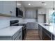 Modern kitchen with gray cabinets, quartz countertops, stainless steel appliances, and stylish backsplash at 2513 Celestial Ct, Charleston, SC 29406