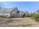 Home with neutral siding, mature landscaping, and a sunroom addition leading to the yard at 9049 Delancey Cir, North Charleston, SC 29406