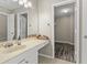 Bright bathroom with vanity, sink, decor, and walk-in closet with wooden floors at 9049 Delancey Cir, North Charleston, SC 29406