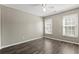 Bedroom with natural light, wooden floors, and two windows at 9049 Delancey Cir, North Charleston, SC 29406
