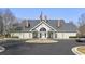 Community clubhouse with ample parking, American flag, and covered front porch seating at 9049 Delancey Cir, North Charleston, SC 29406