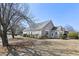 Beautiful home showcasing neutral siding, mature landscaping, and architectural details at 9049 Delancey Cir, North Charleston, SC 29406