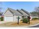 Charming home with neutral siding, mature landscaping, and a community sign at 9049 Delancey Cir, North Charleston, SC 29406
