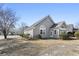 Home featuring neutral siding, mature landscaping, and a sunroom addition at 9049 Delancey Cir, North Charleston, SC 29406