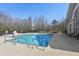 Community outdoor pool surrounded by tables and chairs, featuring lounge seating and landscaping at 9049 Delancey Cir, North Charleston, SC 29406