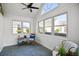 Cozy sunroom with vaulted ceilings, ample windows, and stone tile floors offering a warm and inviting space at 9049 Delancey Cir, North Charleston, SC 29406
