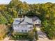 Aerial view showcasing a charming two-story home with a detached garage and lush landscaping at 436 Church St, Mount Pleasant, SC 29464