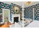 Elegant bedroom with fireplace, statement wallpaper, and a cozy sitting area at 436 Church St, Mount Pleasant, SC 29464