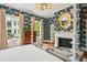 Primary bedroom with fireplace and patterned wallpaper at 436 Church St, Mount Pleasant, SC 29464