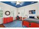 Bright bedroom with a blue ceiling, built in cabinets and orange furniture at 436 Church St, Mount Pleasant, SC 29464