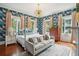 Primary bedroom with a post bed and patterned wallpaper at 436 Church St, Mount Pleasant, SC 29464