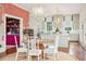 Elegant dining room with a round wooden table and white chairs, and views into the kitchen at 436 Church St, Mount Pleasant, SC 29464