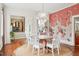Charming dining room features a round wooden table and white chairs, and a crane-themed wallpaper at 436 Church St, Mount Pleasant, SC 29464