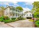 Elegant two-story home with a wraparound porch, detached garage, and well-manicured landscaping at 436 Church St, Mount Pleasant, SC 29464