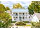 Two-story home with wraparound porch, metal roof, and landscaped yard at 436 Church St, Mount Pleasant, SC 29464