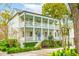 Charming two-story home with a large porch, mature trees, and beautiful landscaping at 436 Church St, Mount Pleasant, SC 29464